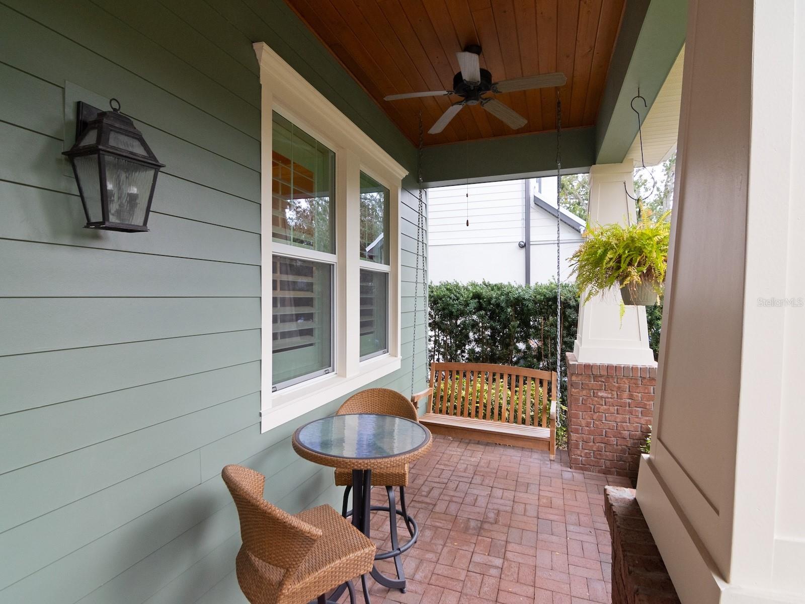 Enjoy relaxing on the front porch overlooking the lushly landscaped front yard.