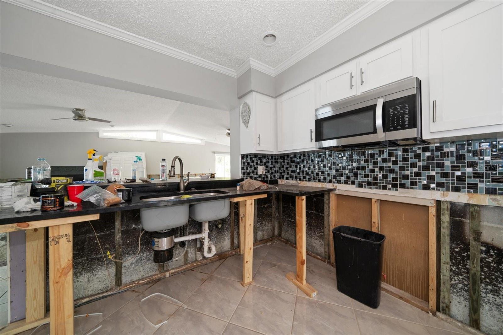 All new kitchen with granite counter tops and dual stainless steel sink. Damaged cabinets to be replaced. Drywall to be installed, textured and painted