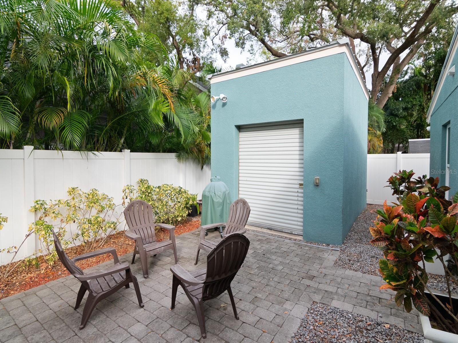 Low maintenance backyard complete with a paver patio, oversized insulated storage shed and turfed area.