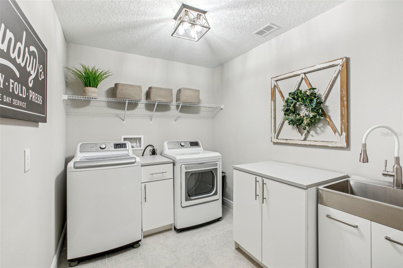 LAUNDRY ROOM WITH BUILT IN SINK AND FOLDING COUNTER