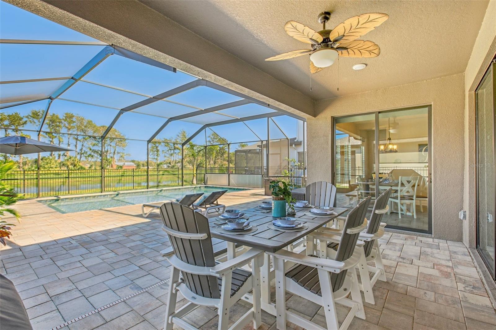 ENJOY BEAUTIFUL FLORIDA LIVING WITH THIS SPACIOUS COVERED AND SCREENED LANAI