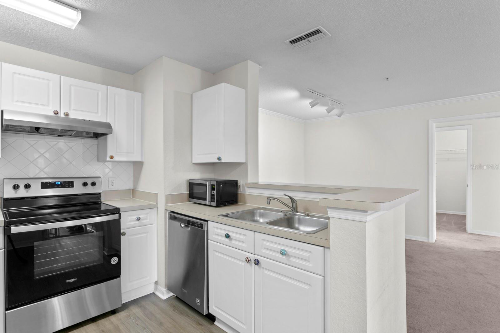 Open-concept views from the kitchen into the living & dining rooms