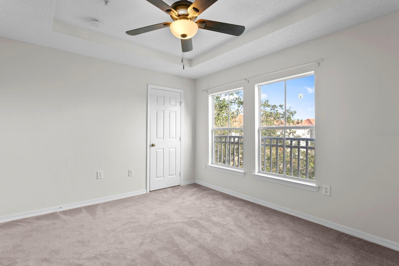 Tray ceilings and neutral colors in the spacious 2nd bedroom