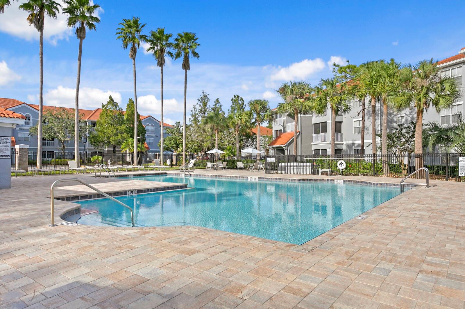 Enjoy soaking up the Florida sunshine along the paver pool deck at the community pool