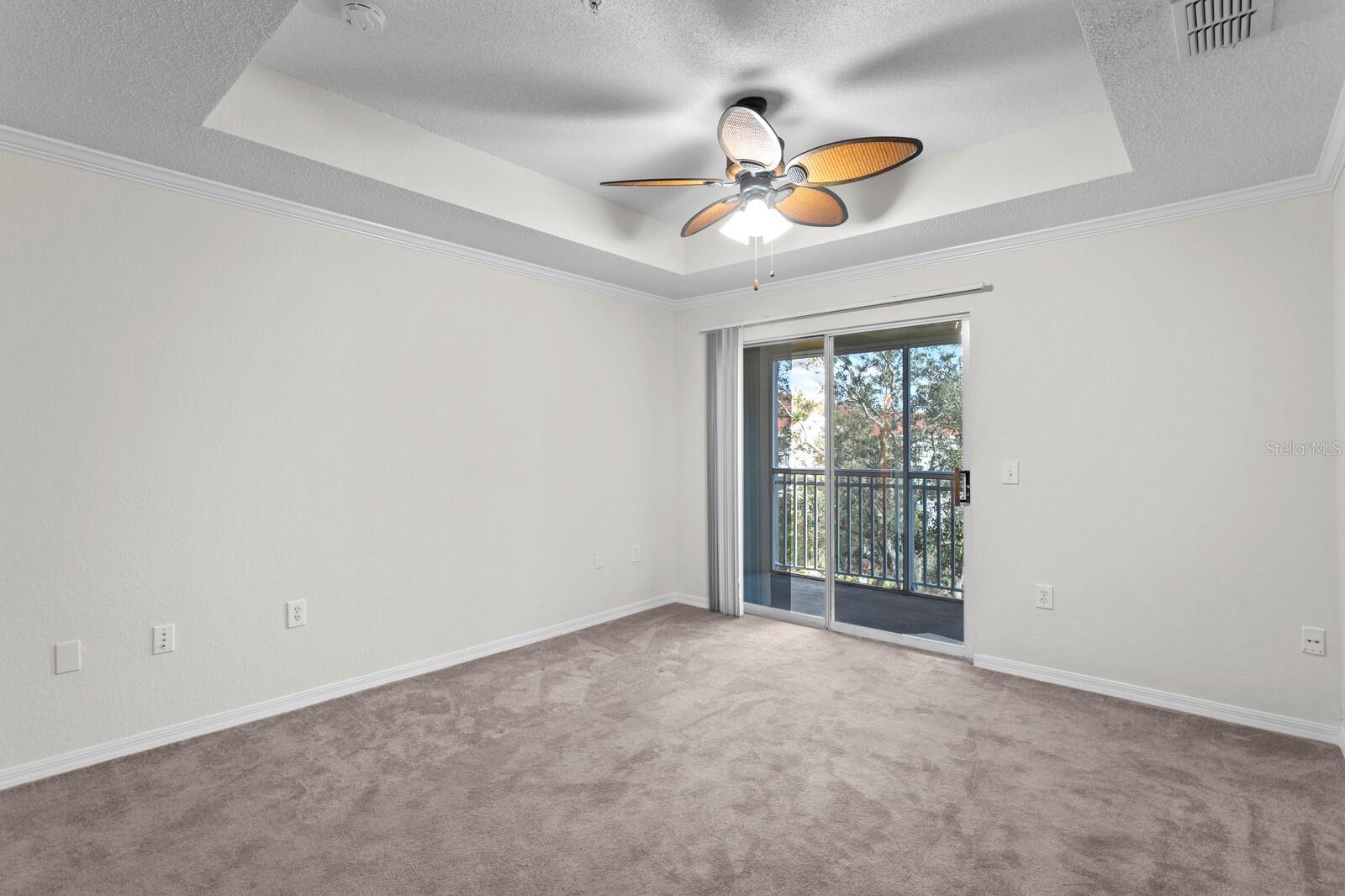 Tray ceilings in the living room with sliding doors out to the screeened lanai