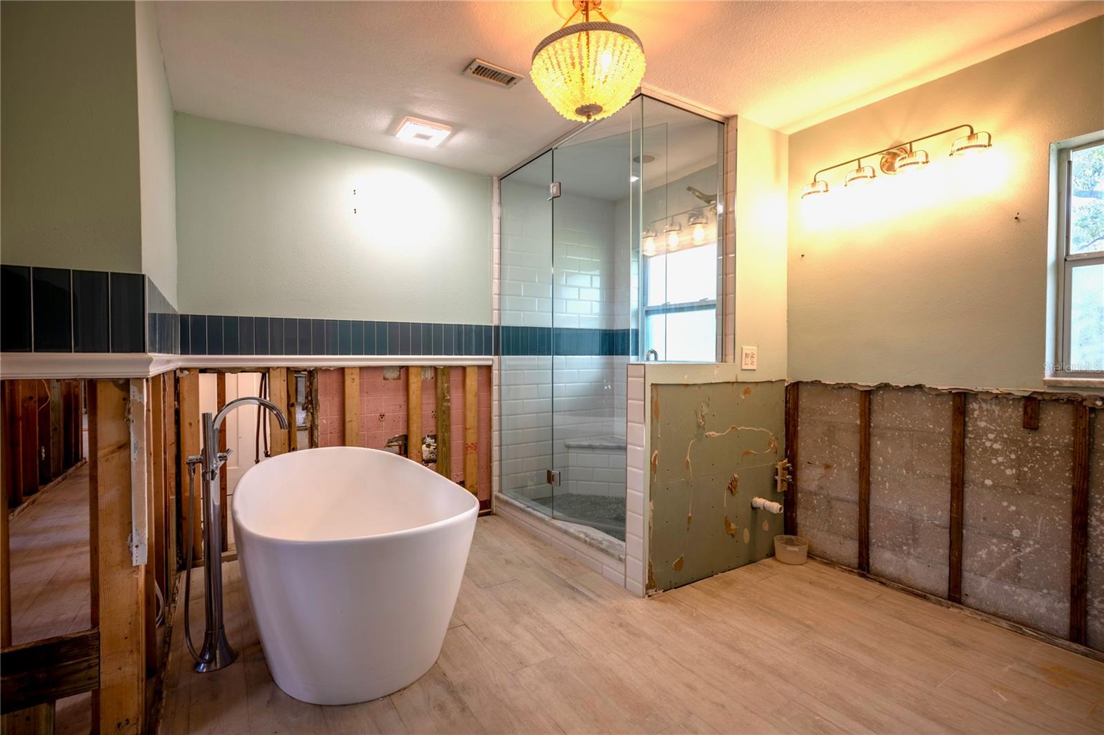 Primary bathroom tub and dual vanity area