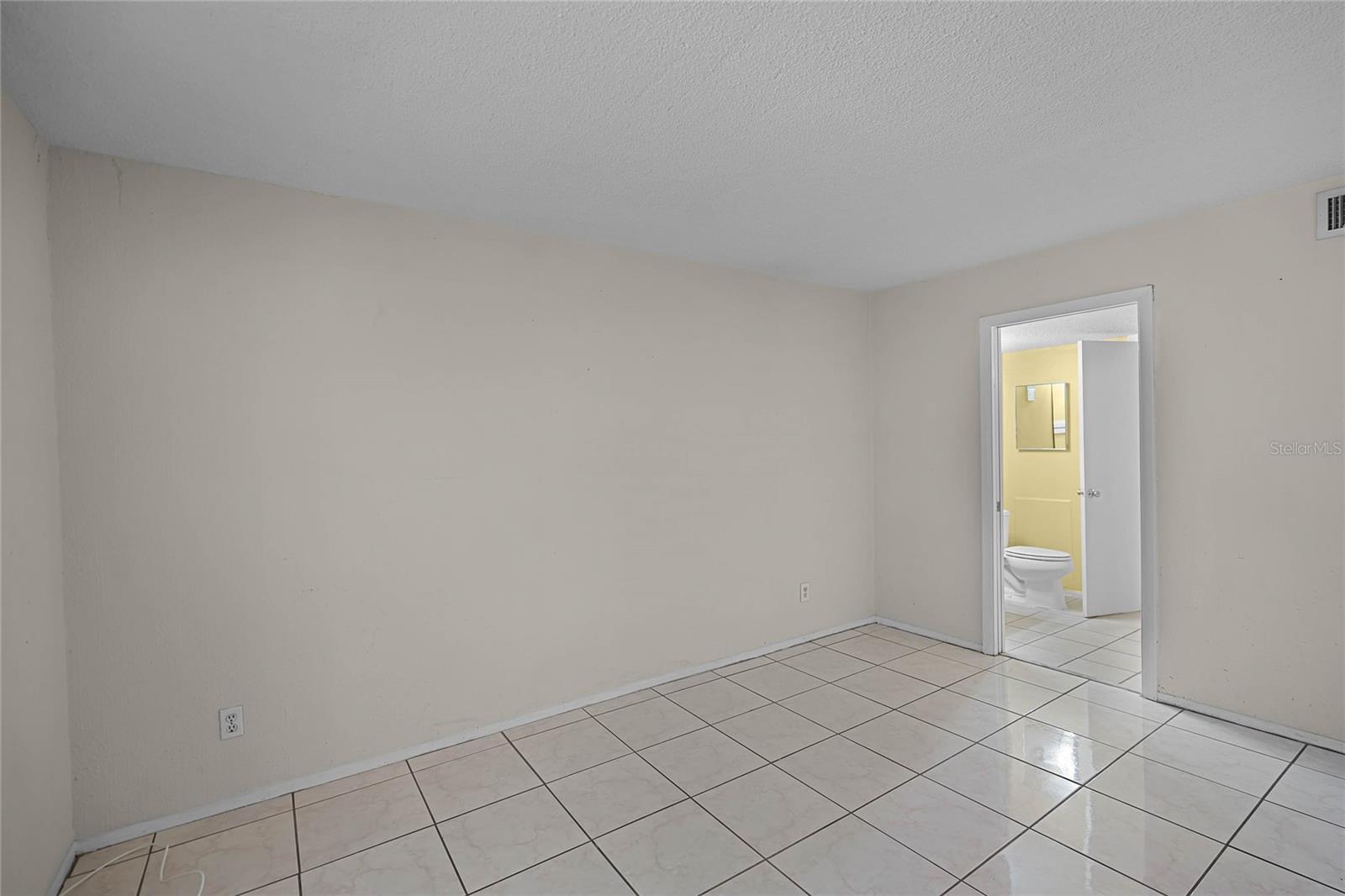 Primary Bedroom & Entrance to Bathroom