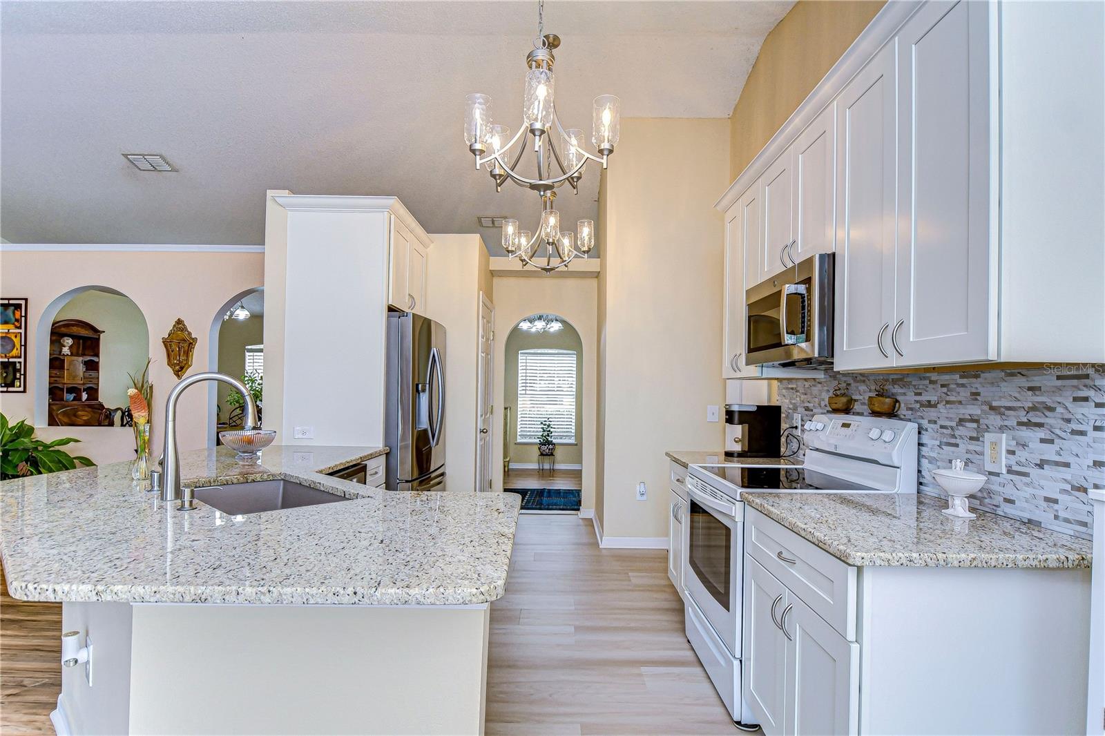 Granite counter tops and a beautiful backsplash complete the kitchen.