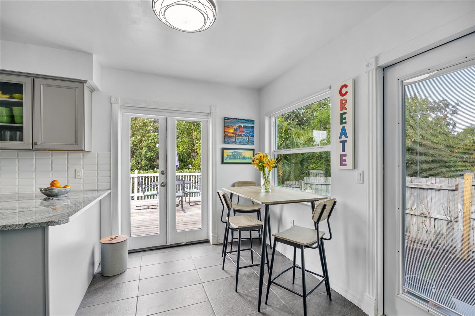 There is a Breakfast Nook at the end of the Kitchen, perfect for quick bite or enjoying your morning coffee.    The  French Doors lead out to the deck, one of several outdoor lounging areas at this home!