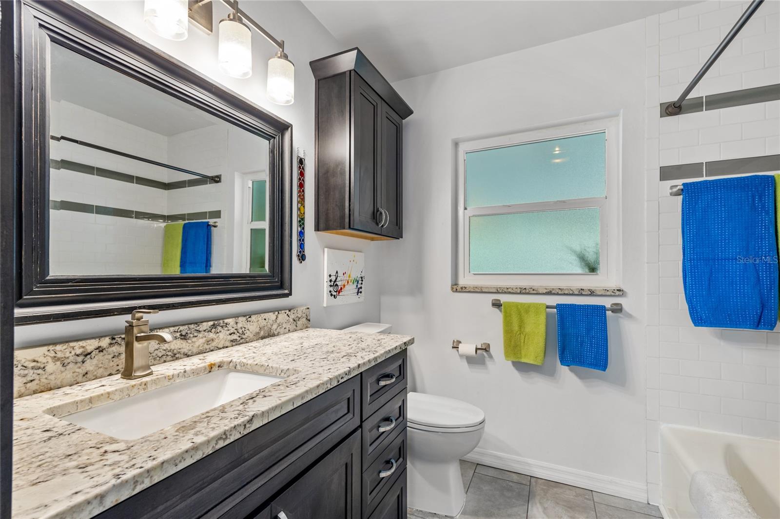 The Guest Bathroom has been fully renovated and has a large single sink vanity and tub/shower combo.