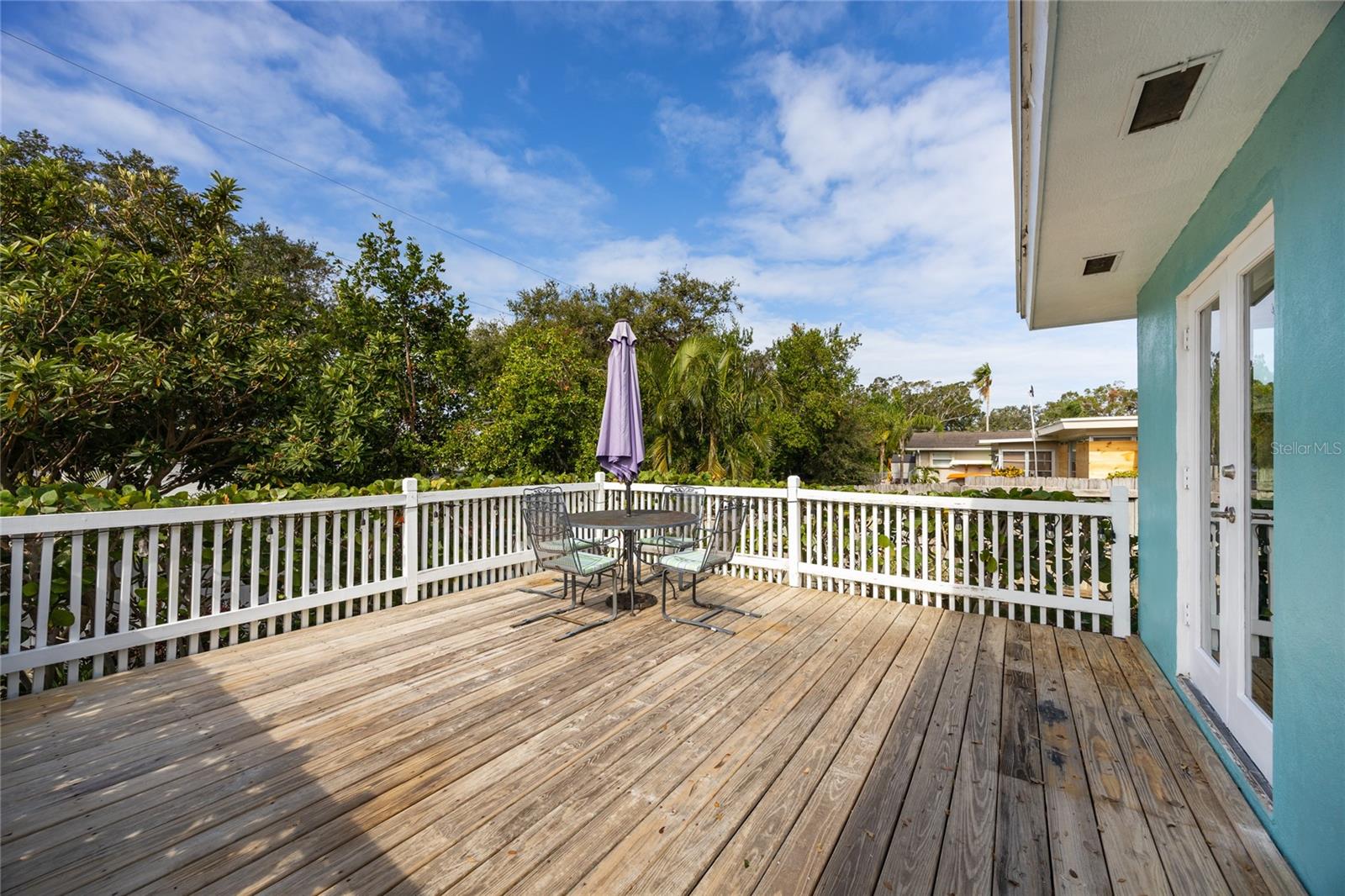 This large deck is accessible off of the kitchen and from the back yard as well.