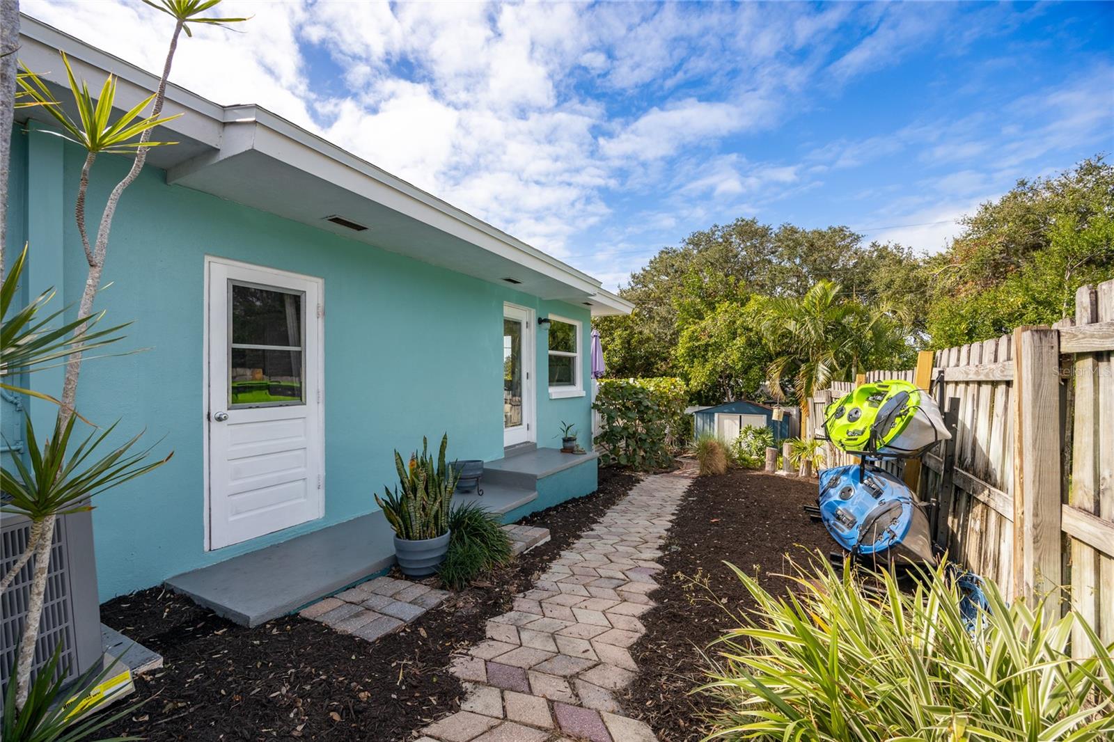 Side yard showing side door to garage and also side door into Breakfast nook.