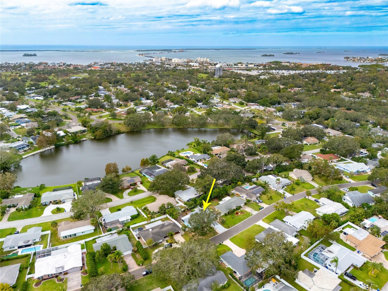 This aerial view of the home shows the proximity to the Dunedin Causeway which is the gateway to Honeymoon and Caladesi Island State Parks just a short bike ride away.   Also shown is Lake Saundra, at the heart of Fairway Estates.