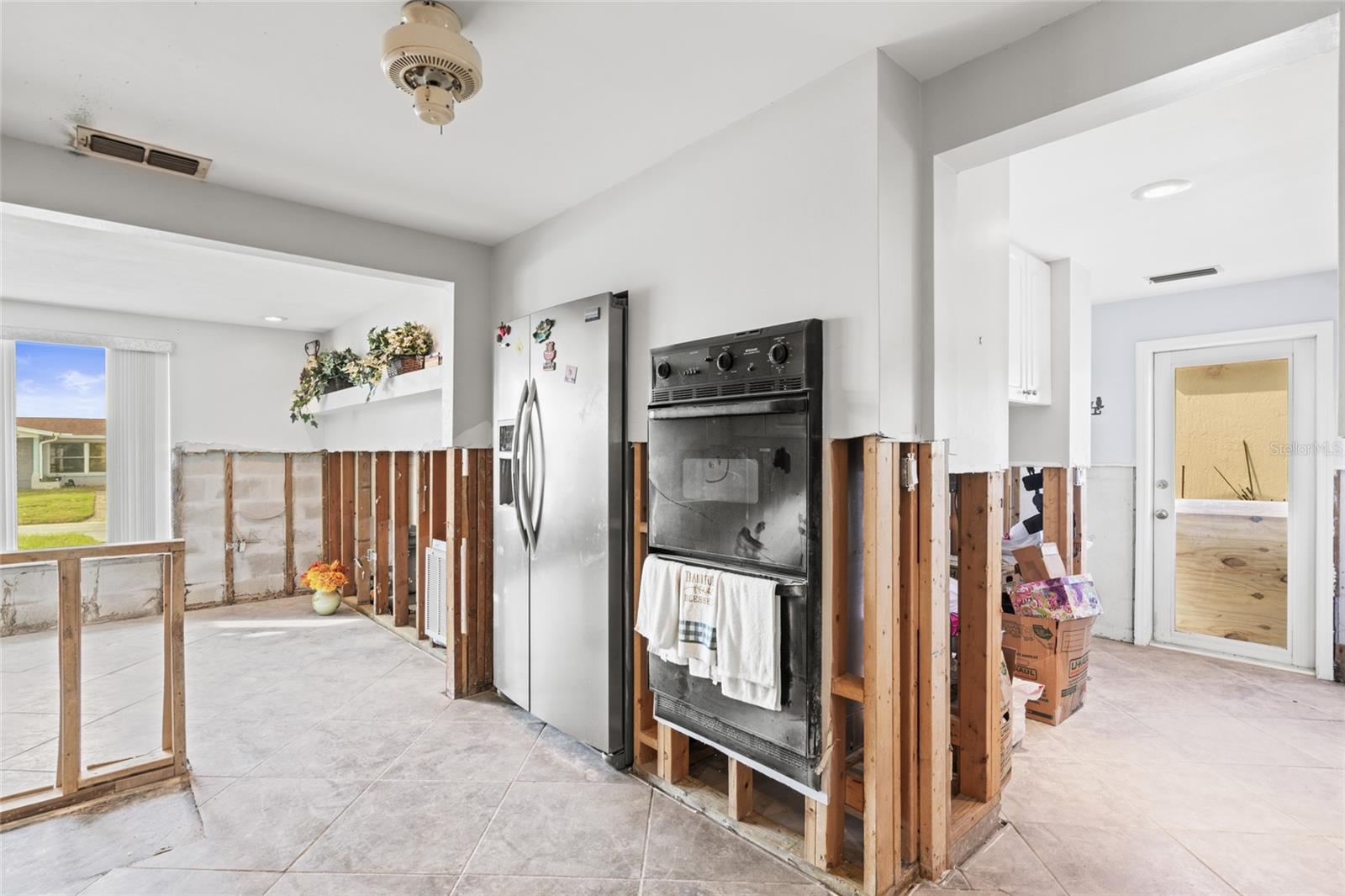 Kitchen leading into the laundry room and living area