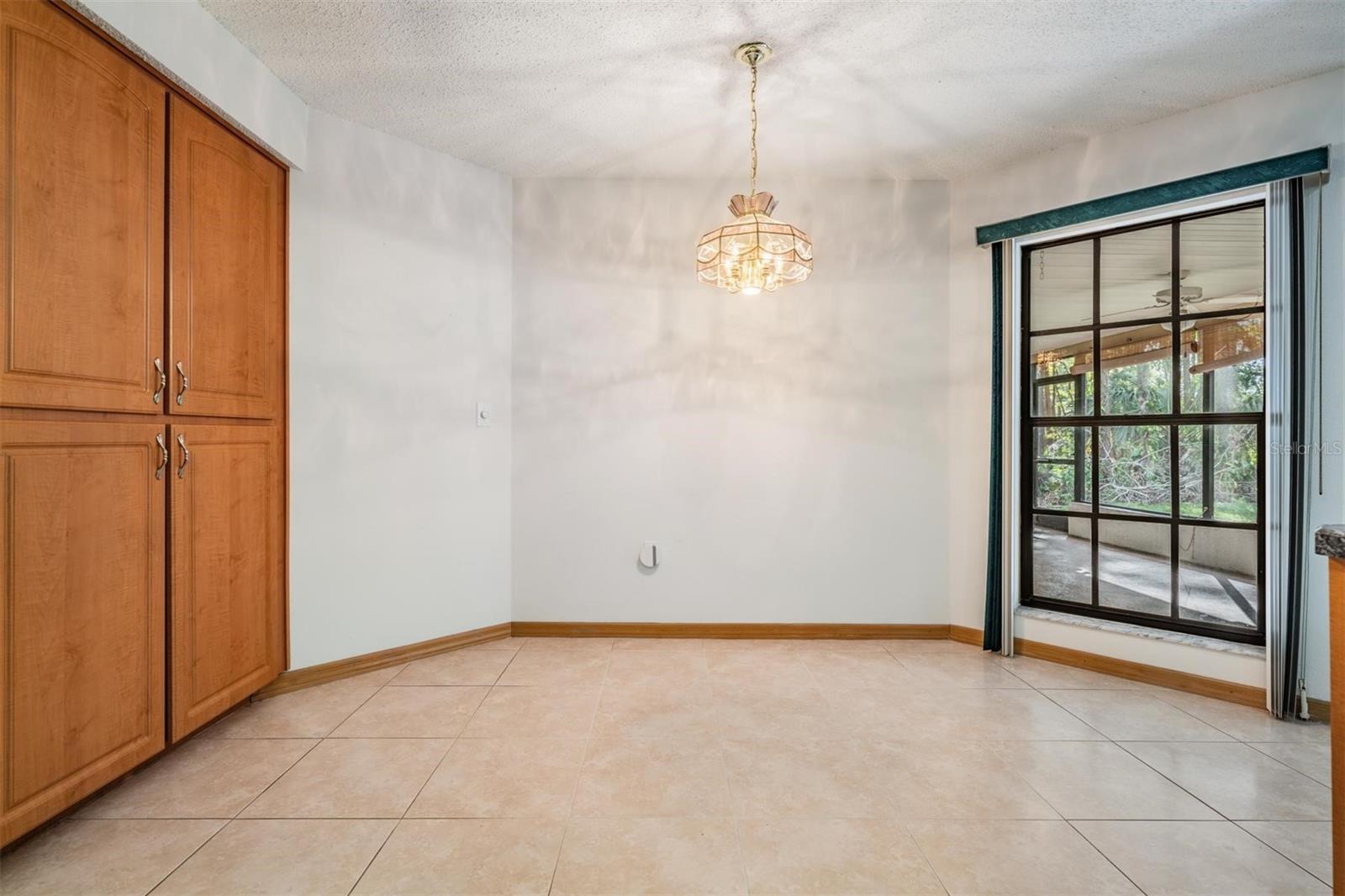 Large kitchen nook with storage options and view of patio