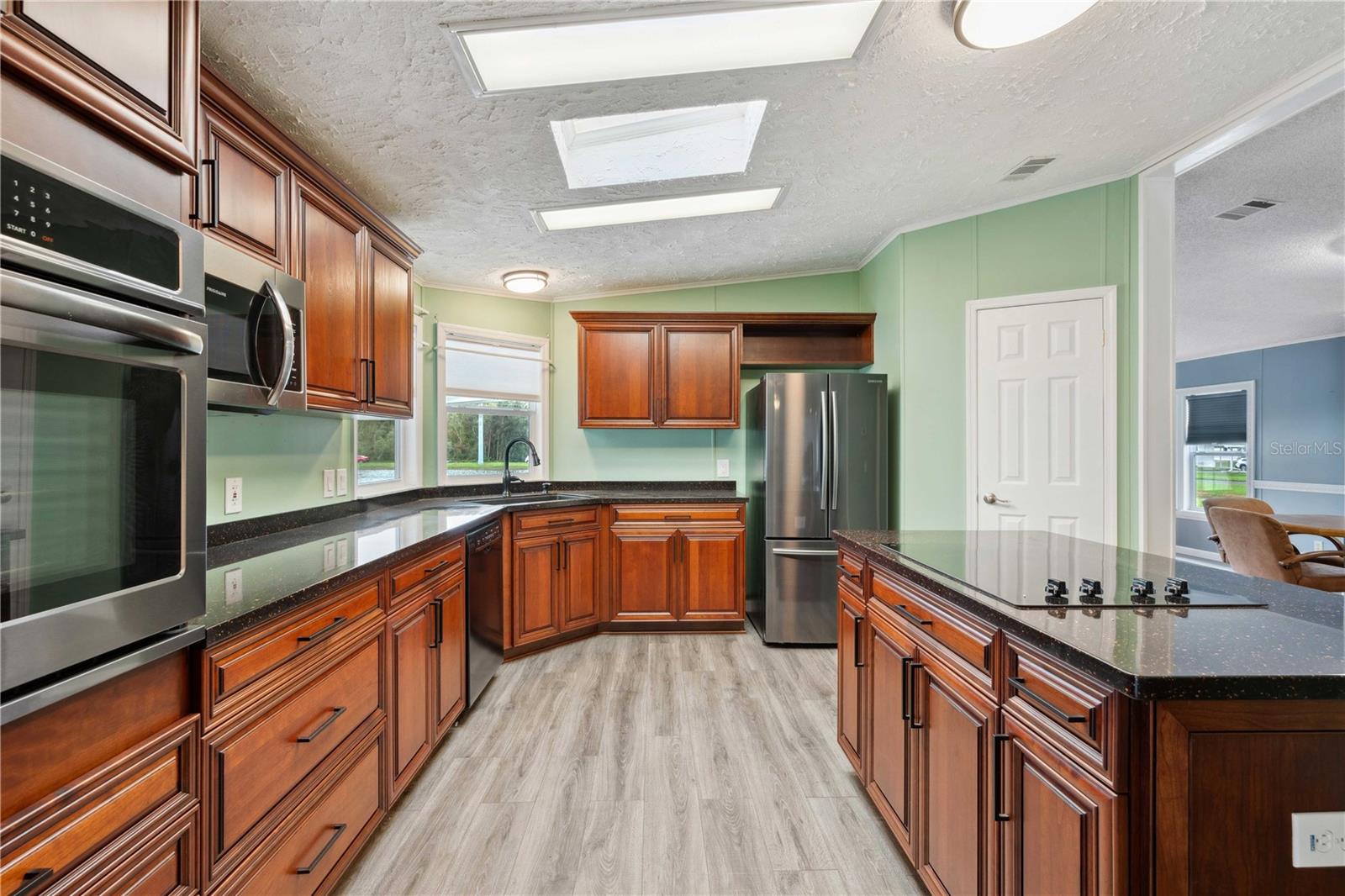 This kitchen is fully updated with flooring, Granet counter tops, wood cabinets, updated appliances, and so much more.