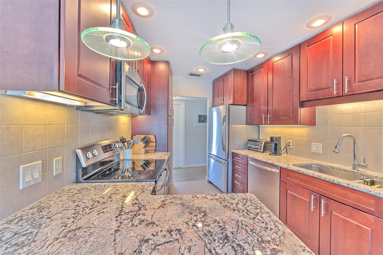 Kitchen with beautiful granite and Stainlee Steel Appliances