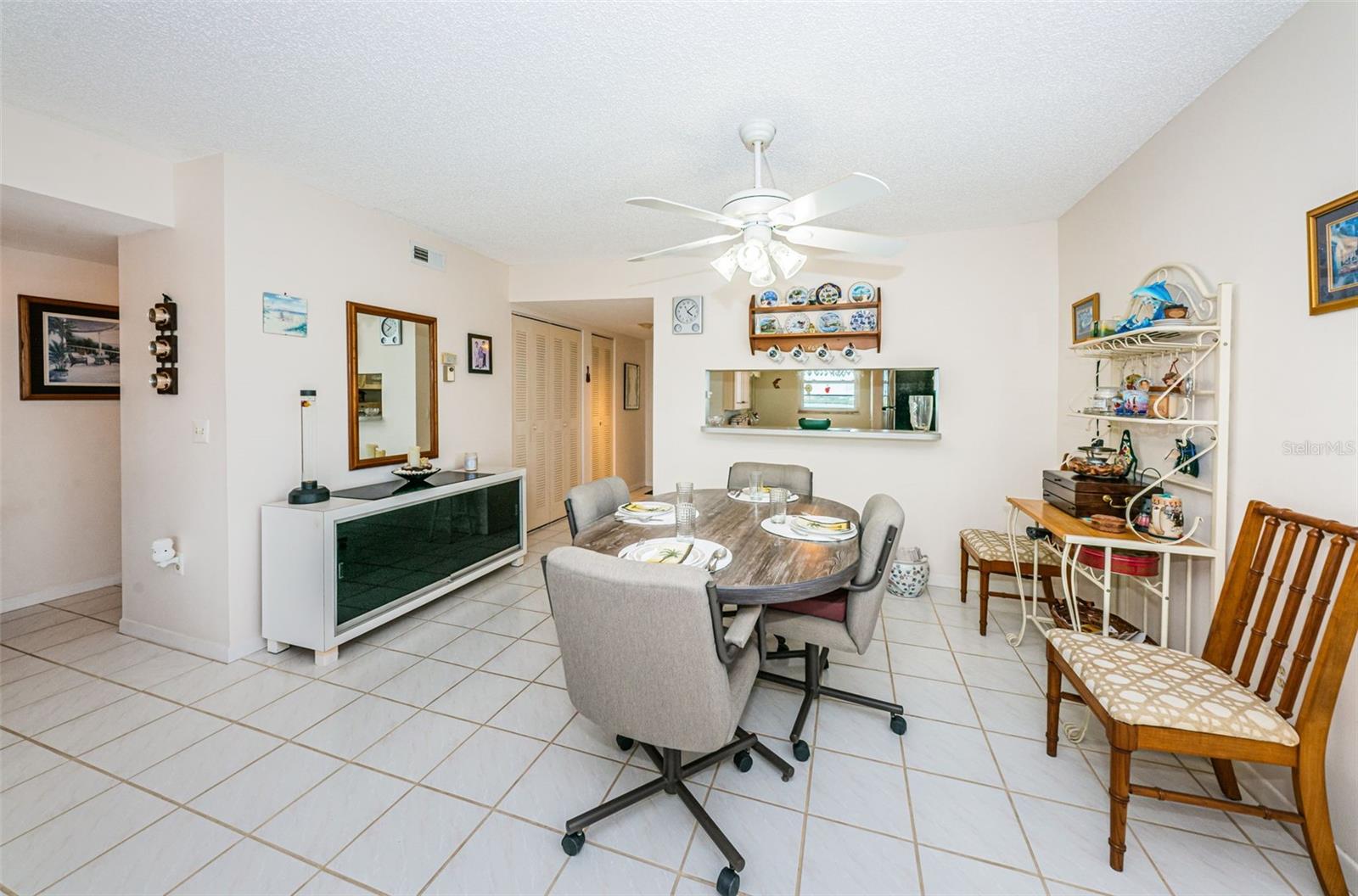 .. Dining Area With Kitchen in Background. Front Entrance Past Kitchen on Left.