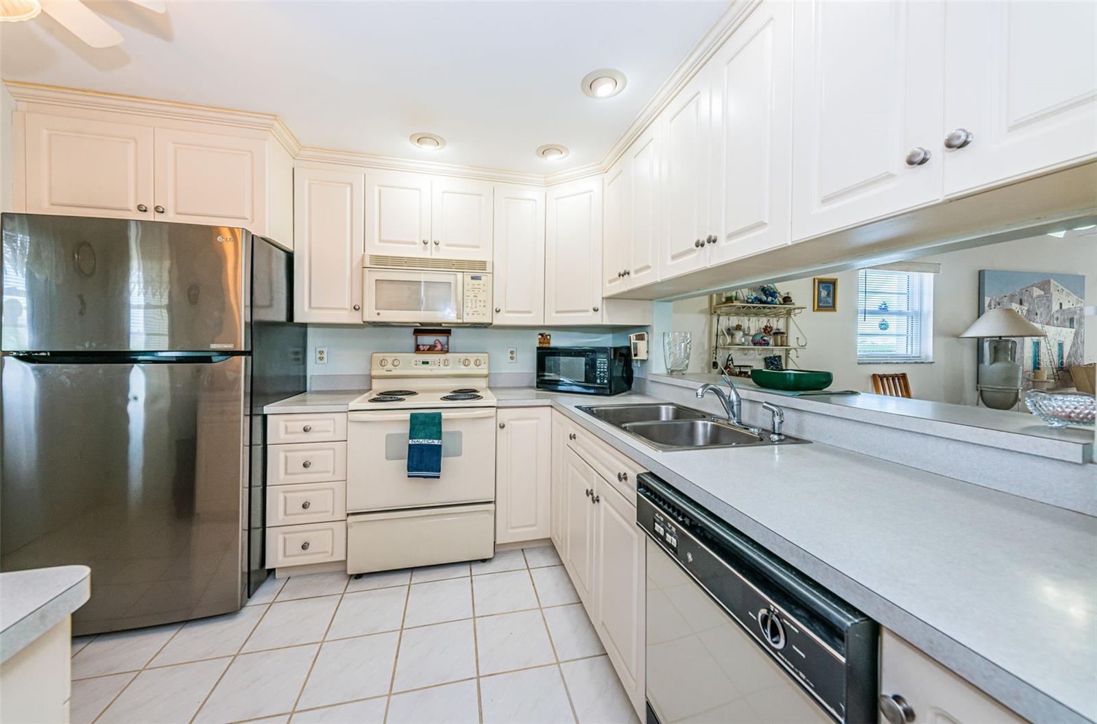 ..Well Lit Kitchen - Looking In From Hallway. Plenty of Cabinetry & Storage Space.. Unit Also Controls Small Storage Bin on 4th Floor. 4x4  Good for Christmas Decorations etc..