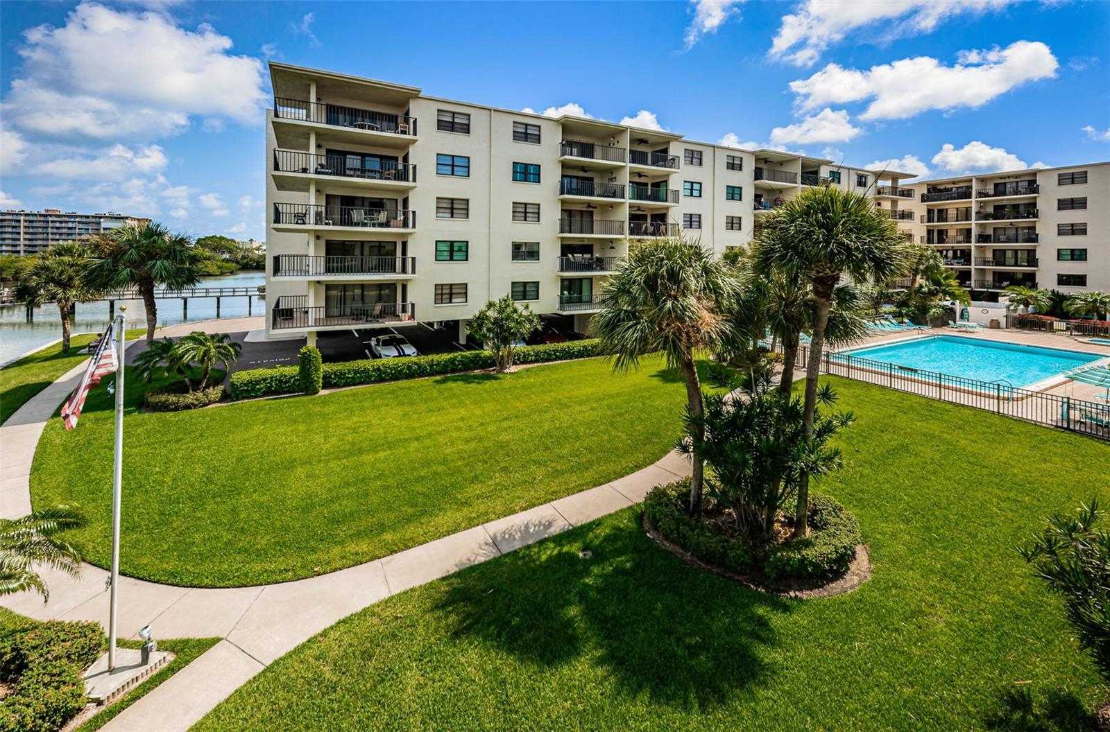 .. Wonderful Shot of the Grounds.. Picture Taken From Where Unit #301 Balcony  is Located But Facing West Towards Pool Area.. Owner Chnaged Out the Winders on the Pool side of the Condo - Negating any Exterior Noise.