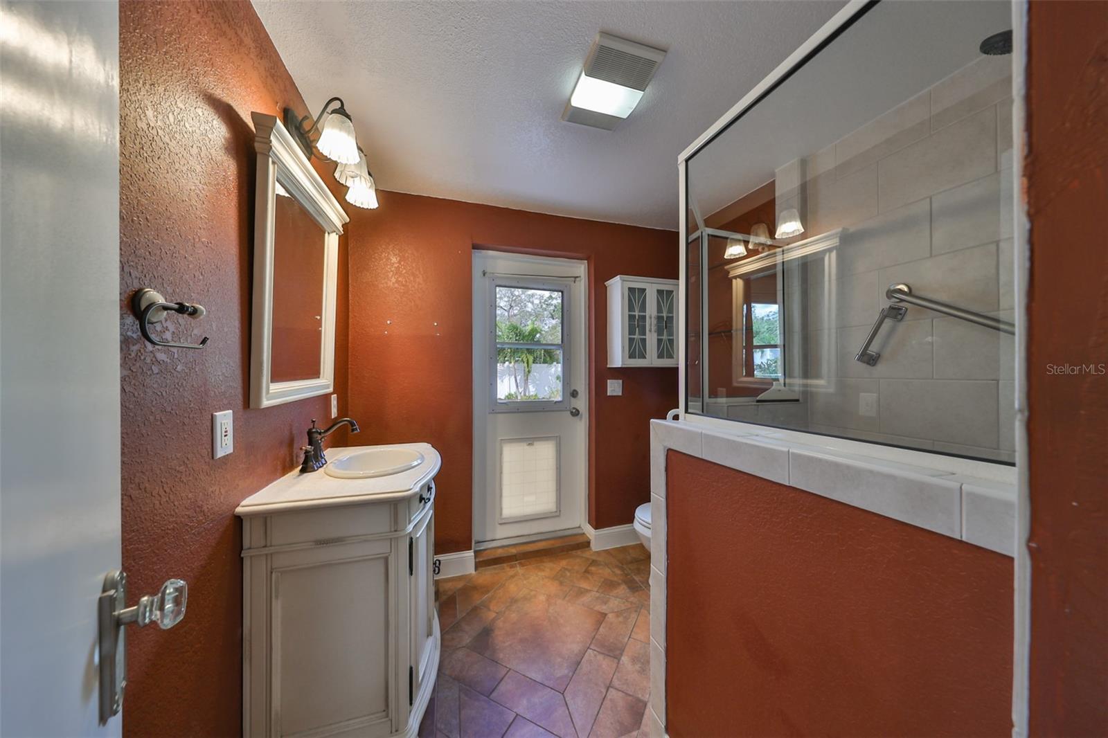 Bedroom #3 with a door leading to the pool and paver patio area