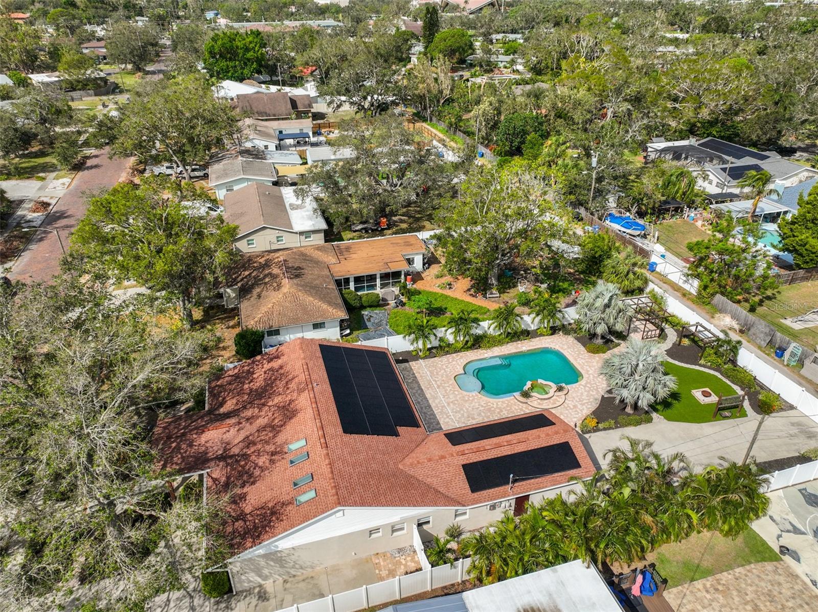 Bird's Eye view of the property with a view of the pool and solar panels