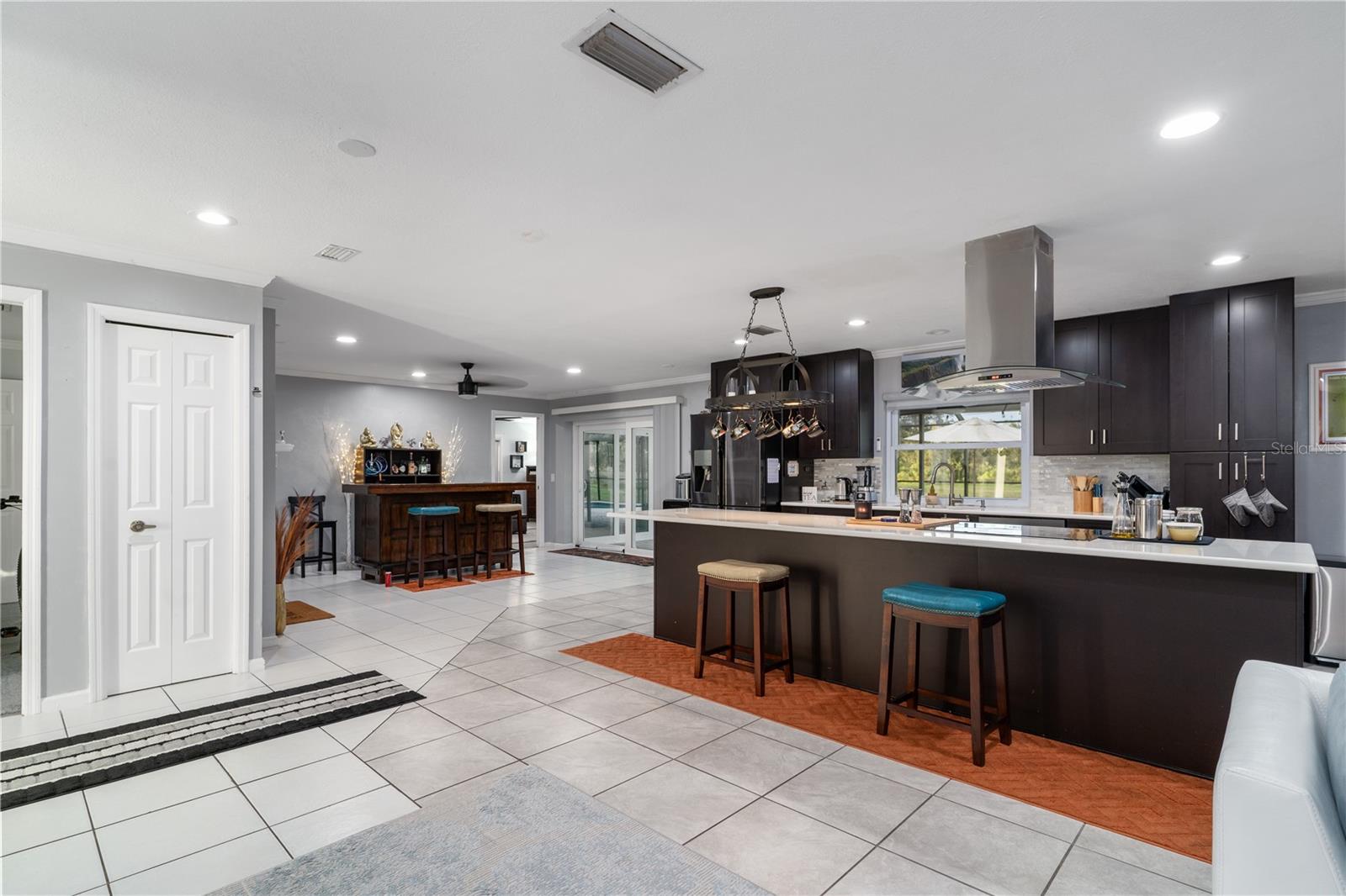 View from living room to Kitchen, dry bar and outside sliding doors