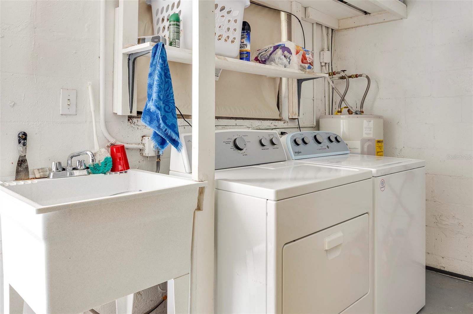 LAUNDRY AREA WITH THE UTILITY SINK IN THE GARAGE