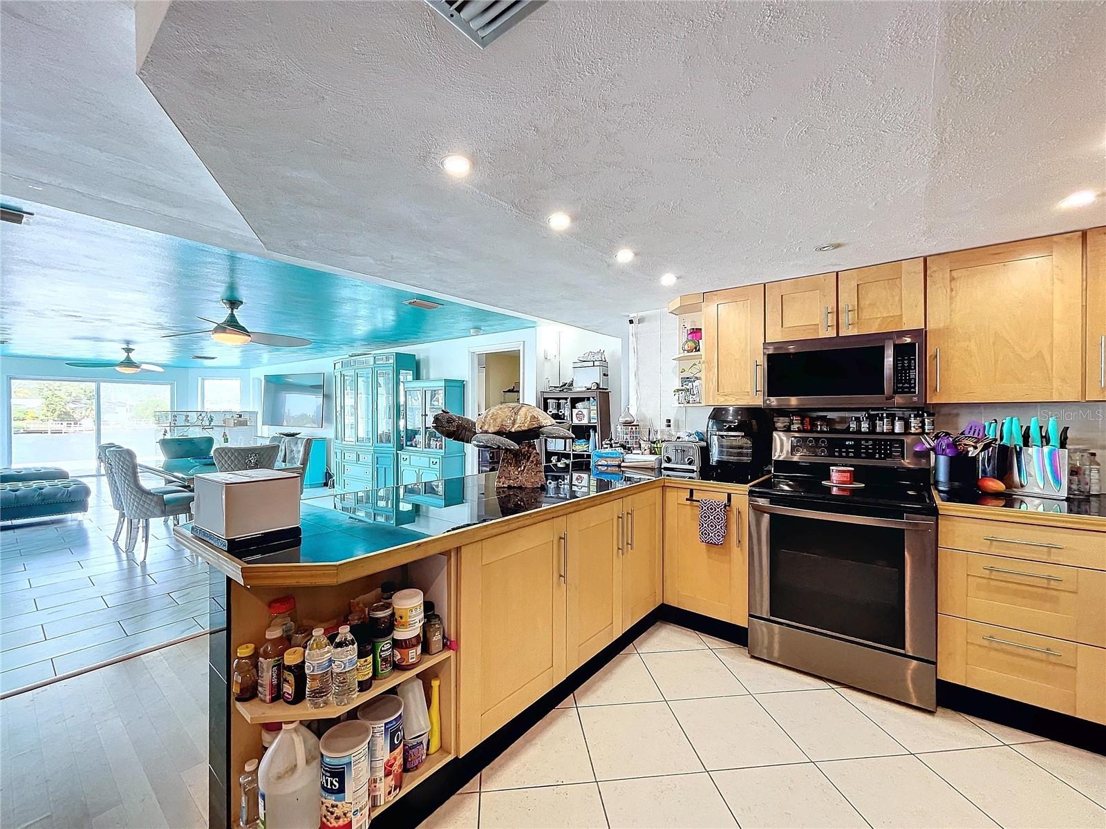 Open kitchen brings in ample sunshine from the living room windows.