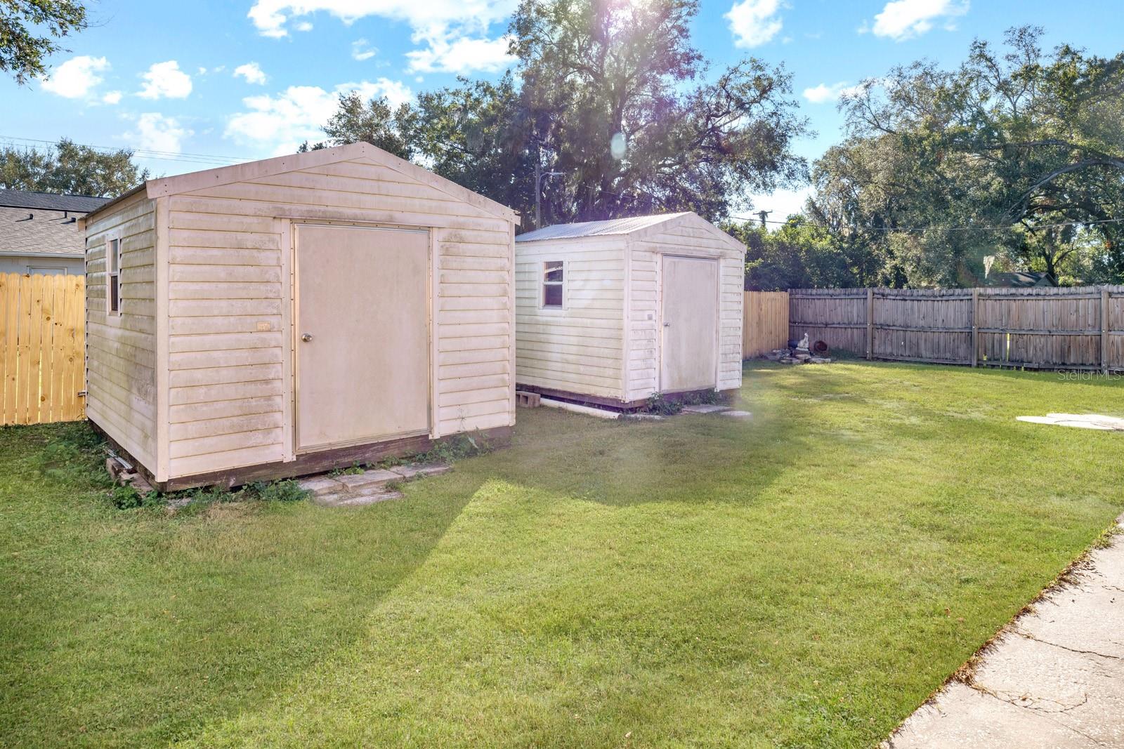 2 Large Storage Sheds with Built-in Shelving.