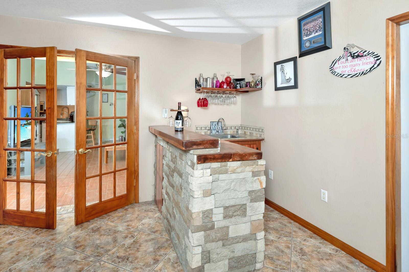 Stone Covered Wet Bar with a Mini-Fridge and Sink Great for Entertaining !