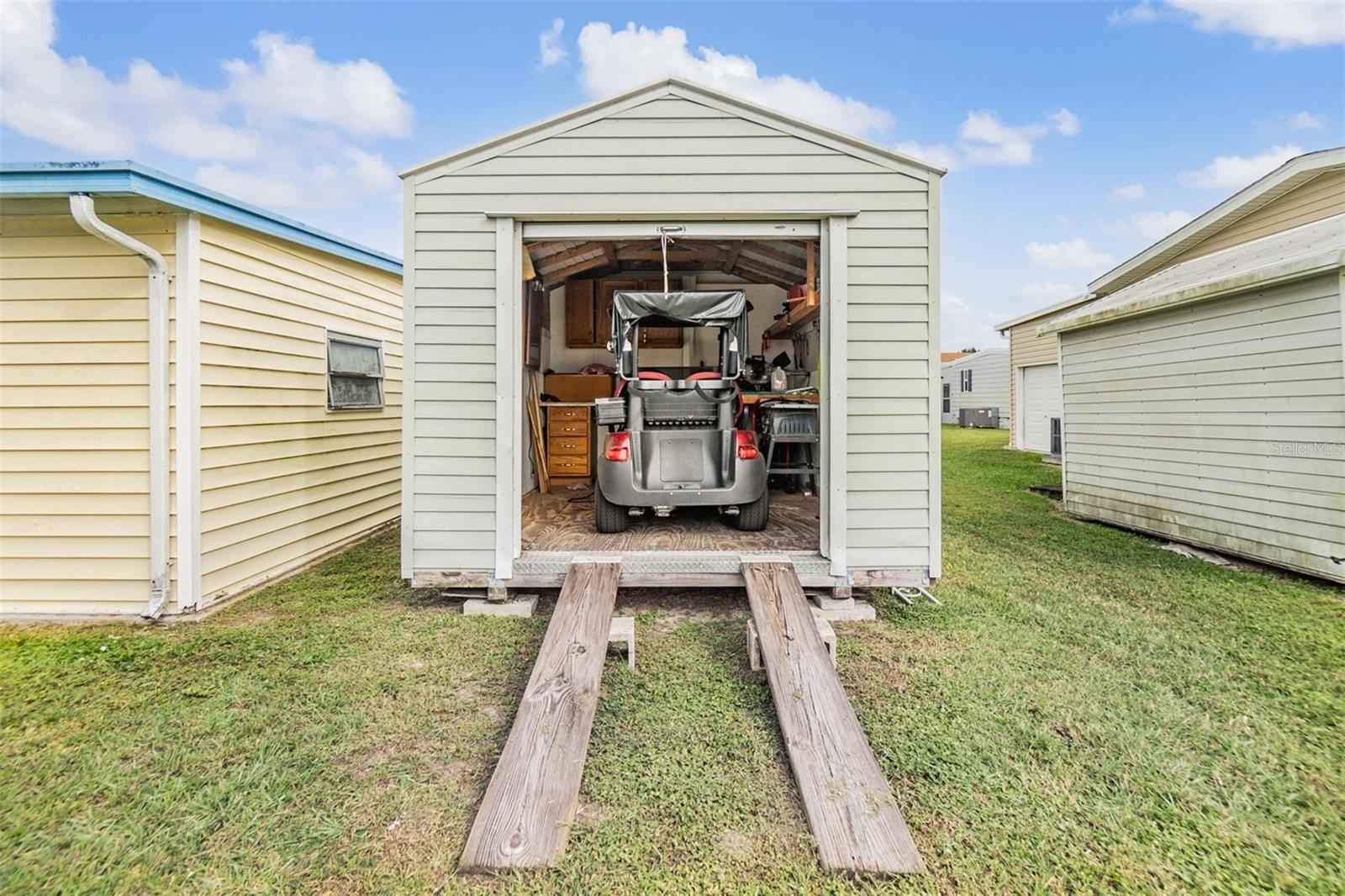 Golf cart storage area is detached. Golf cart is negotiable.