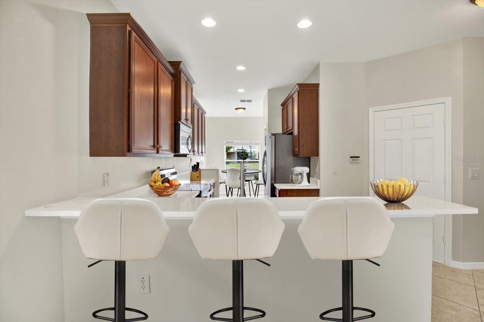 Kitchen w/ New Quartz Countertops and Dining Area (Virtually Staged)