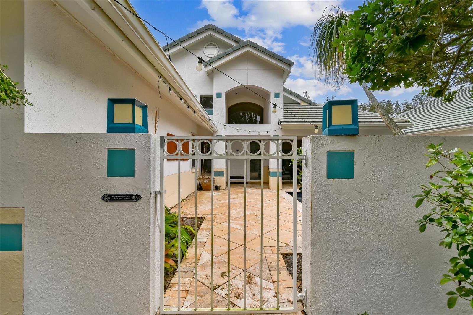 Enter through the wrought iron gate