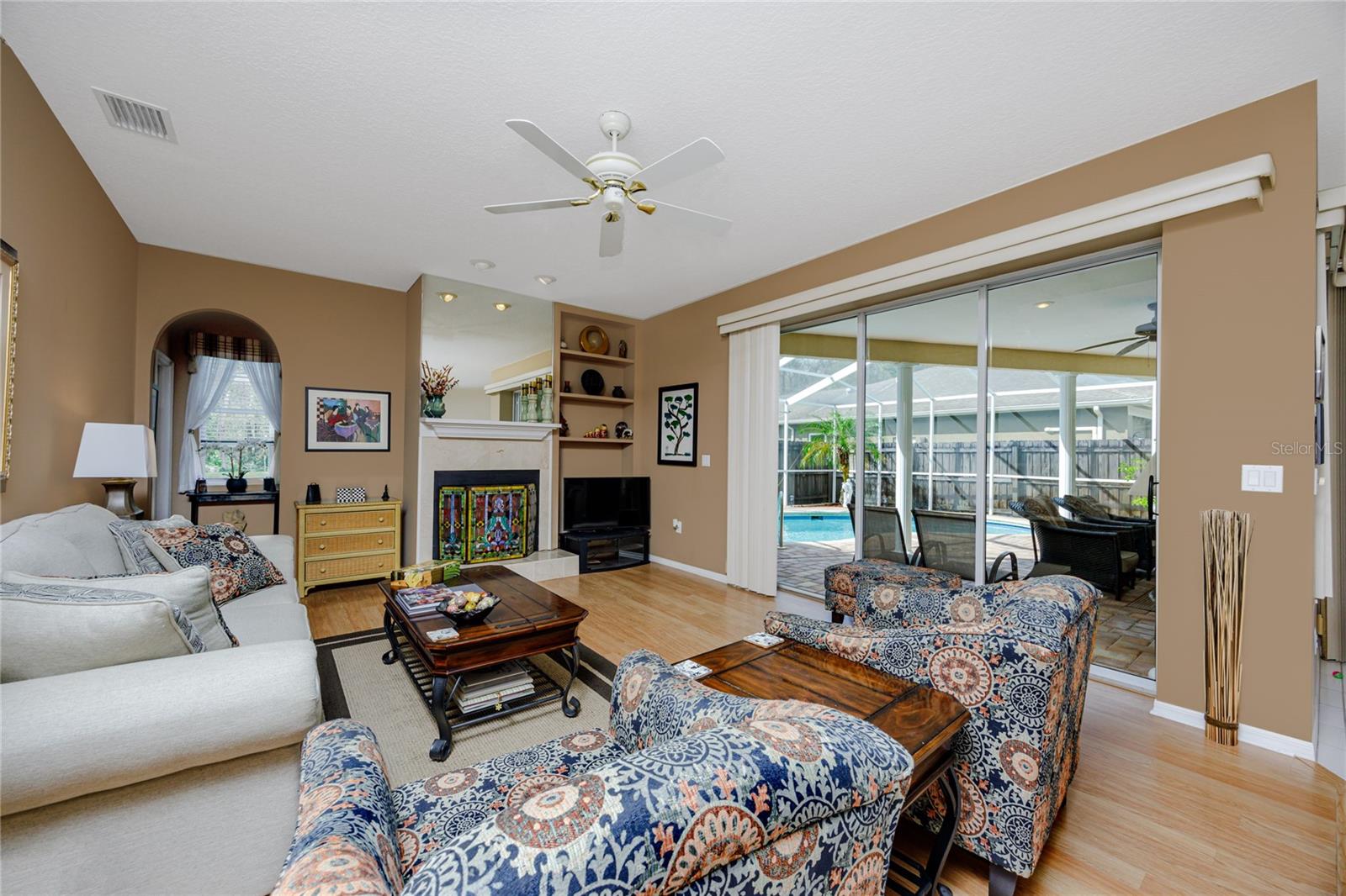 Family room with triple sliders to patio -4466 Worthington Ct, Palm Harbor, FL 34685