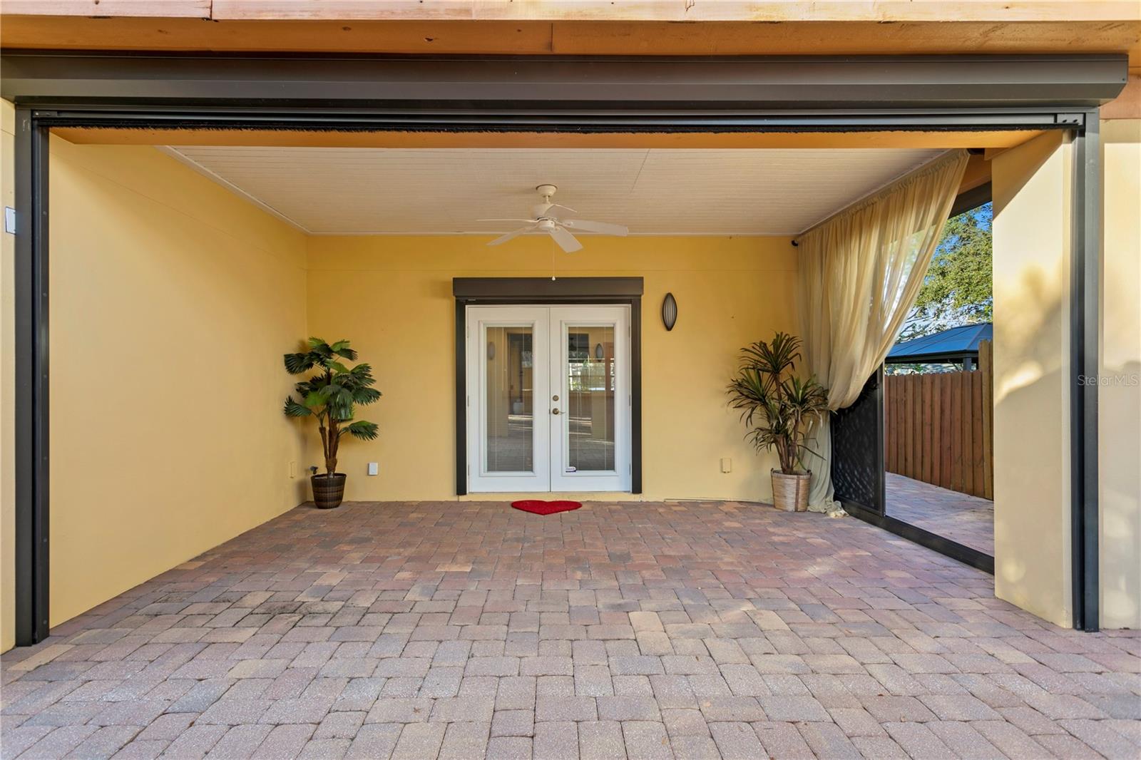 Sun Room off of dining room closes up with electric roll down screens