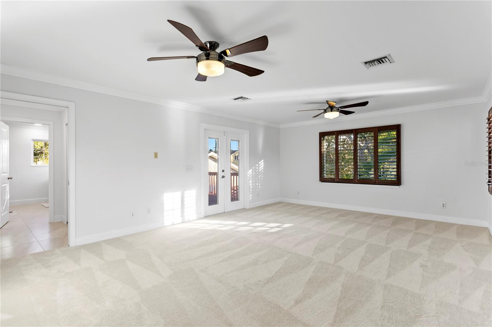 Primary Bedroom with Ensuite Bath and Walk-In Closets