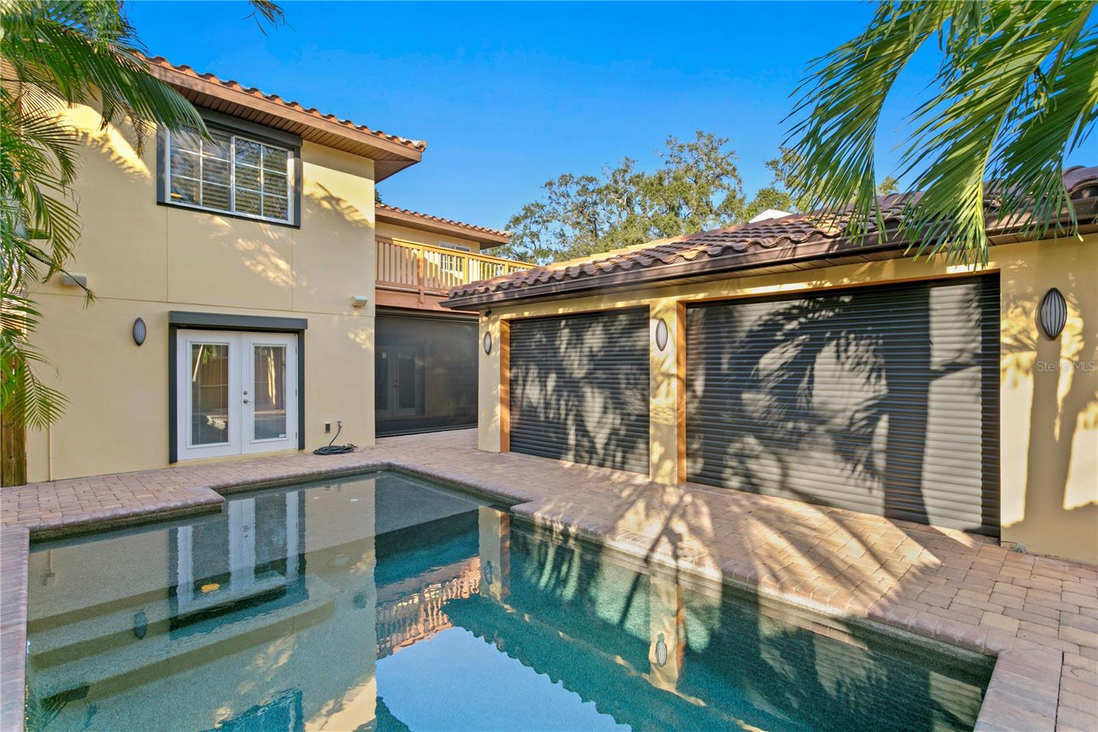 Cabana closes up with electric hurricane shutters and can serve as a single car garage. Sun Room with electric screens closed