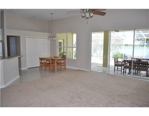 View from near the front door to triple sliders before LVP flooring was installed where the carpet is in this photo.  Could you come home to this outside view every day?