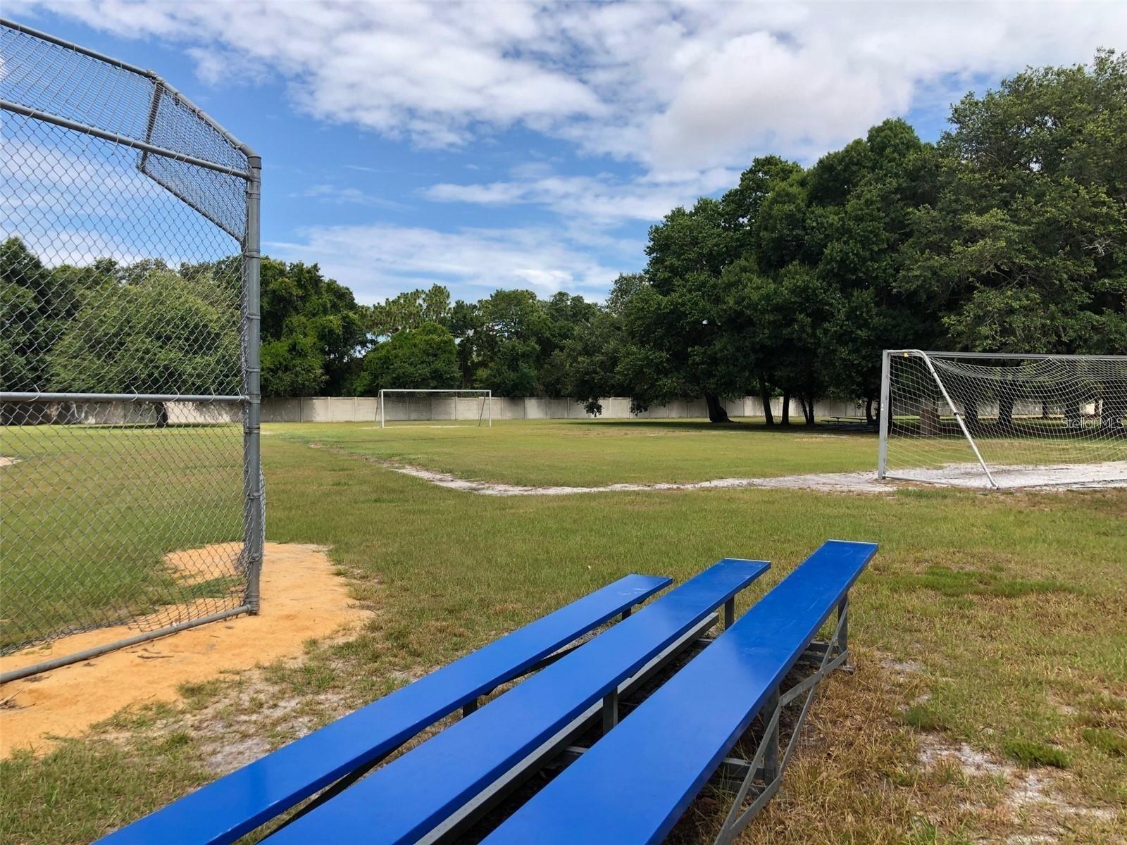 Baseball field benches with soccer field in the background