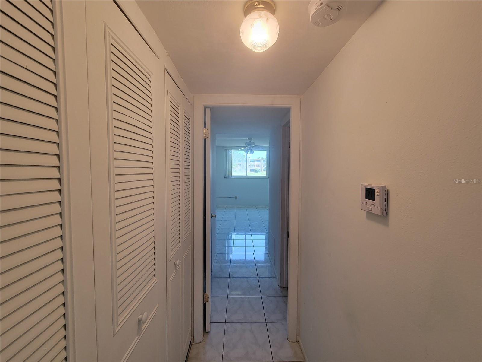 Hallway with linen closet and A/C