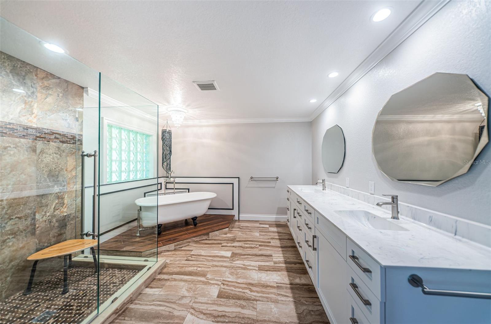 Gorgeous primary bathroom with antique claw soaking tub and large shower