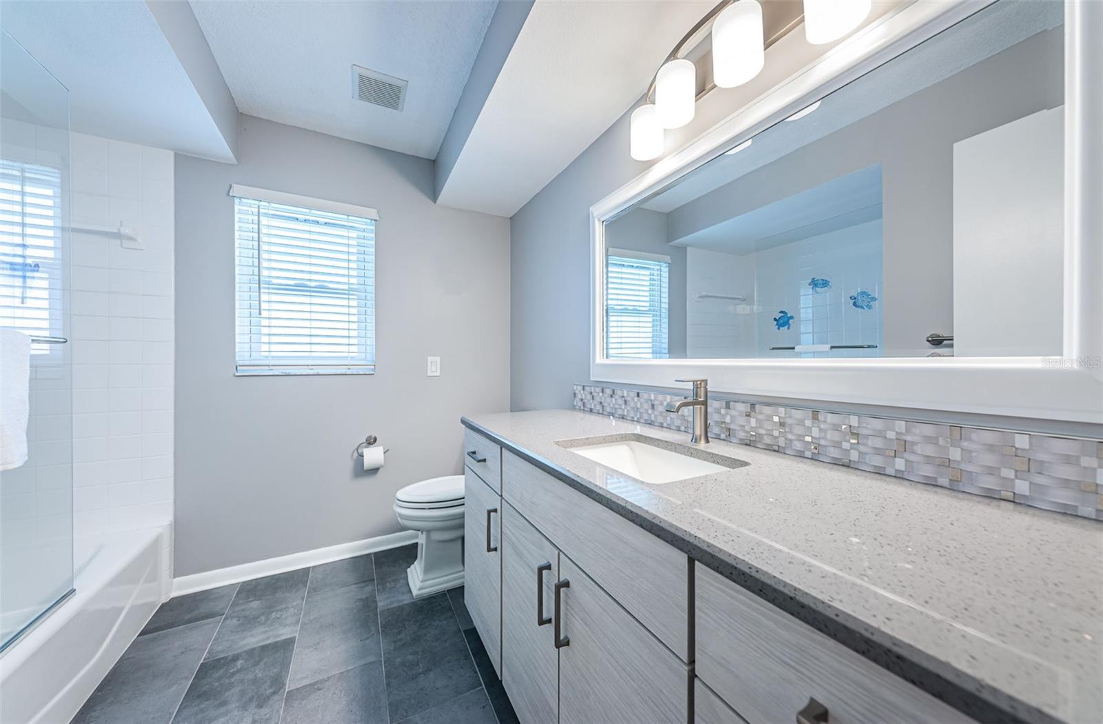 Renovated guest bathroom with tub