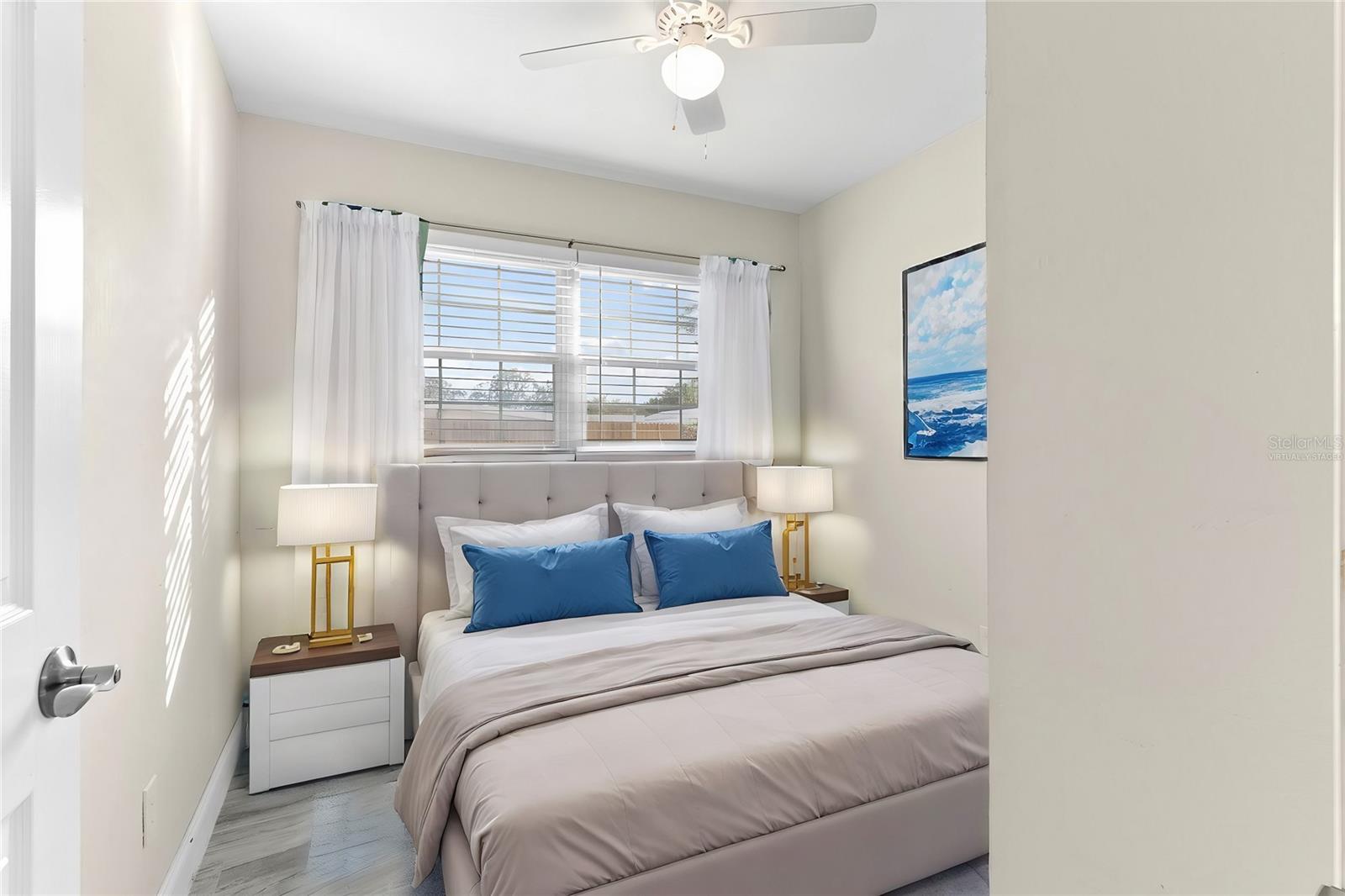 Bedroom 2 with nice view of garden and fenced in yard virtually staged