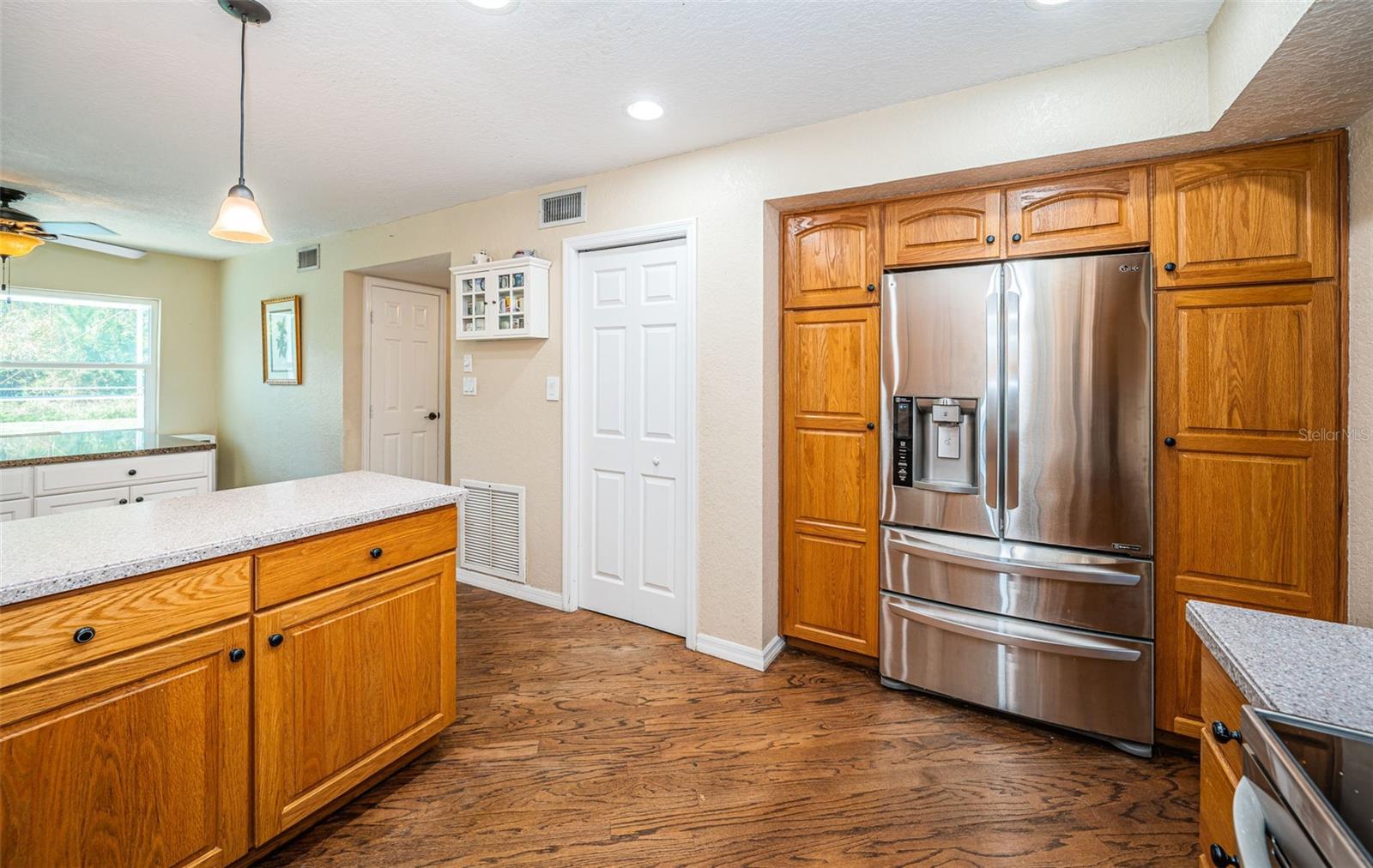 Continuous hardwood flooring from living room thru kitchen and dining room.