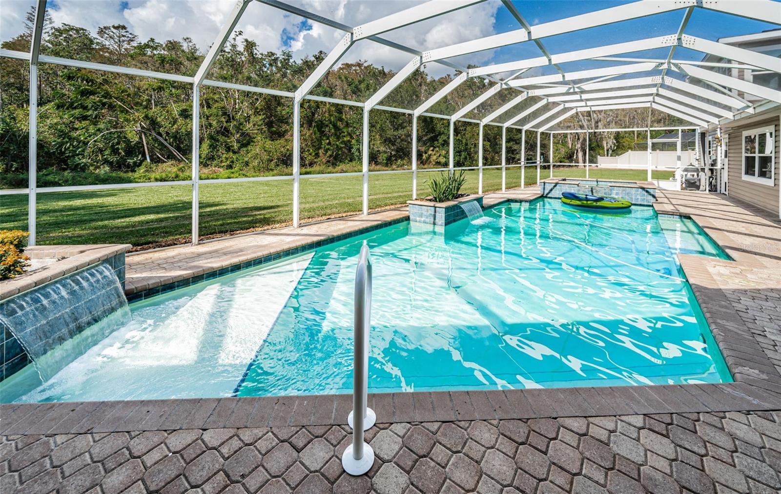 Two waterfalls add to the calming effects of floating in your new pool.