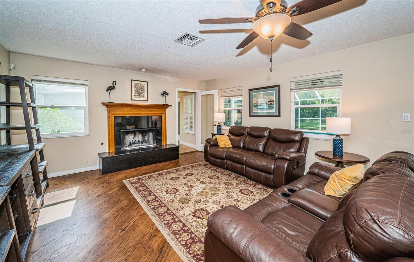 Comfortable living room with wood burning fireplace.