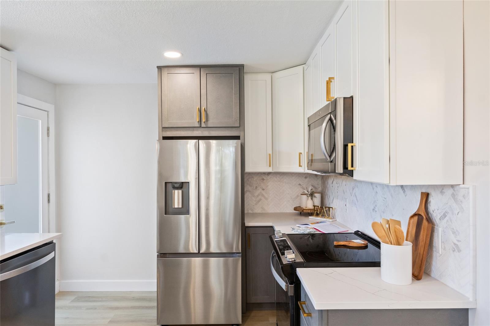 This kitchen has it all new appliances, fresh paint, new flooring, &  new cabinets with gold hardware