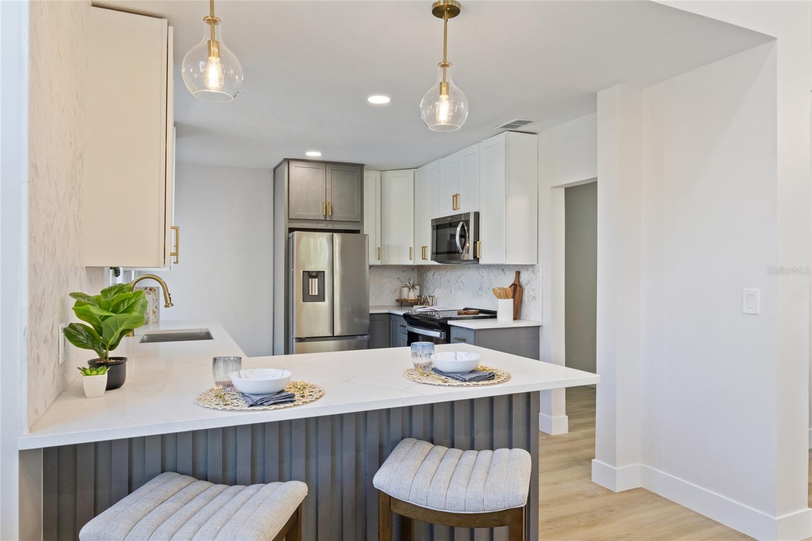 This kitchen has it all new appliances, fresh paint, new flooring, &  new cabinets with gold hardware