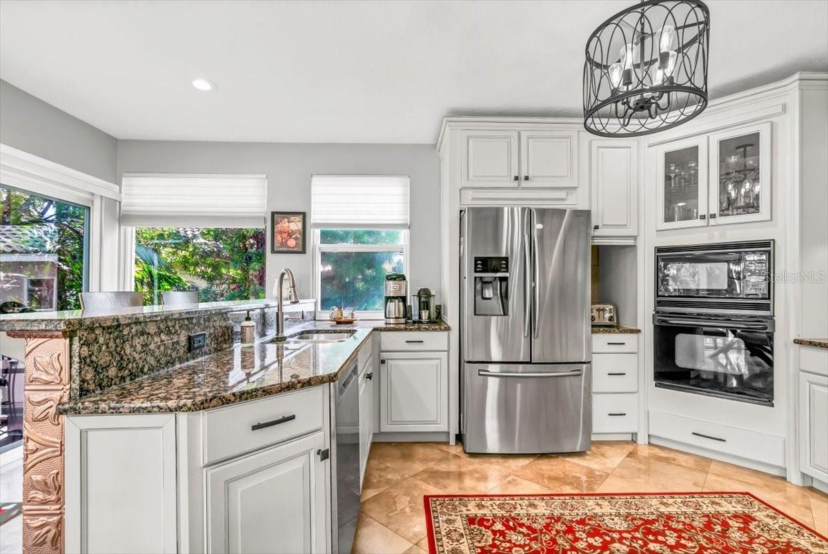 A well-appointed kitchen boasts ample storage and comes equipped with a built-in microwave and oven.